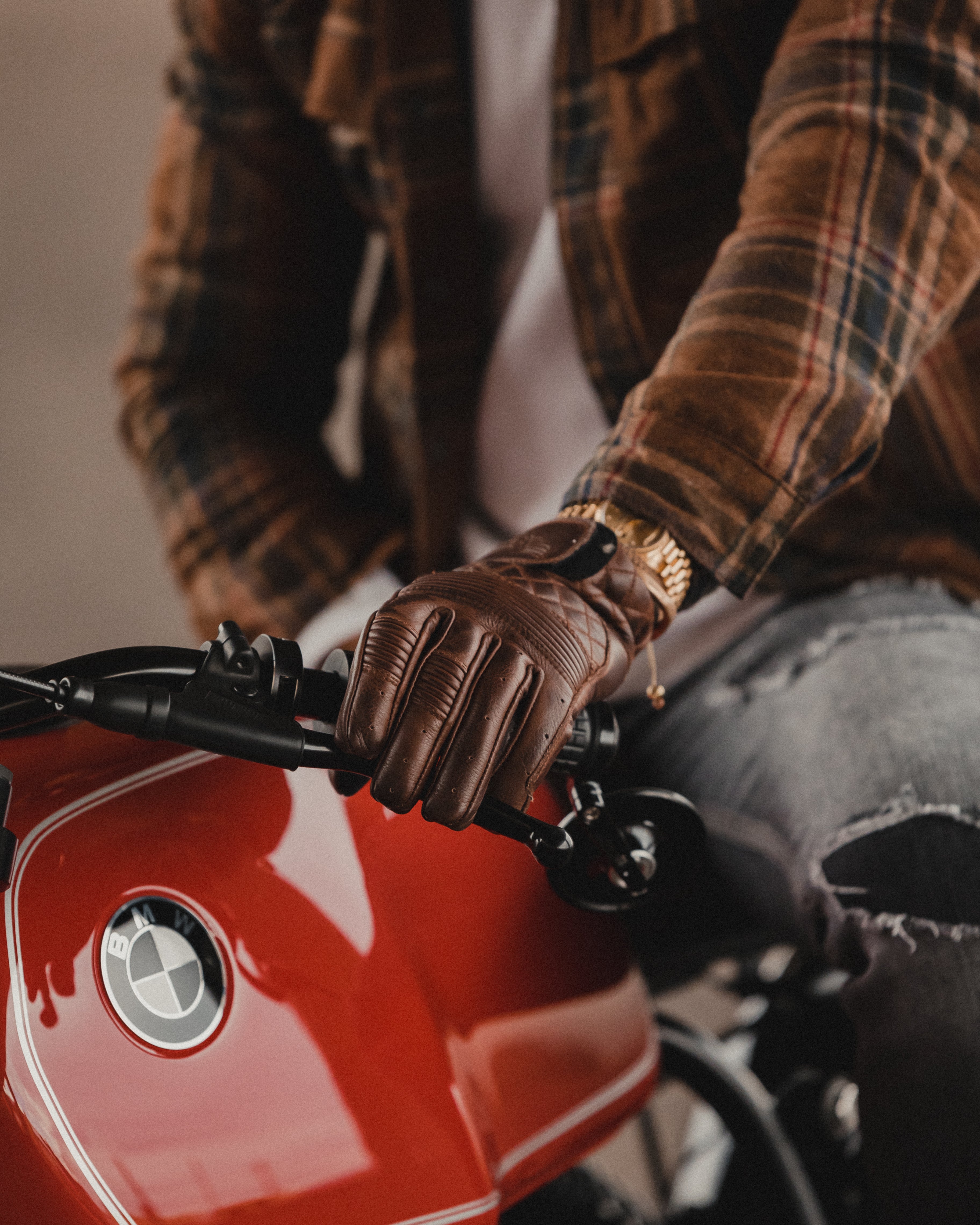 Why are leather motorcycle gloves essential for riding?